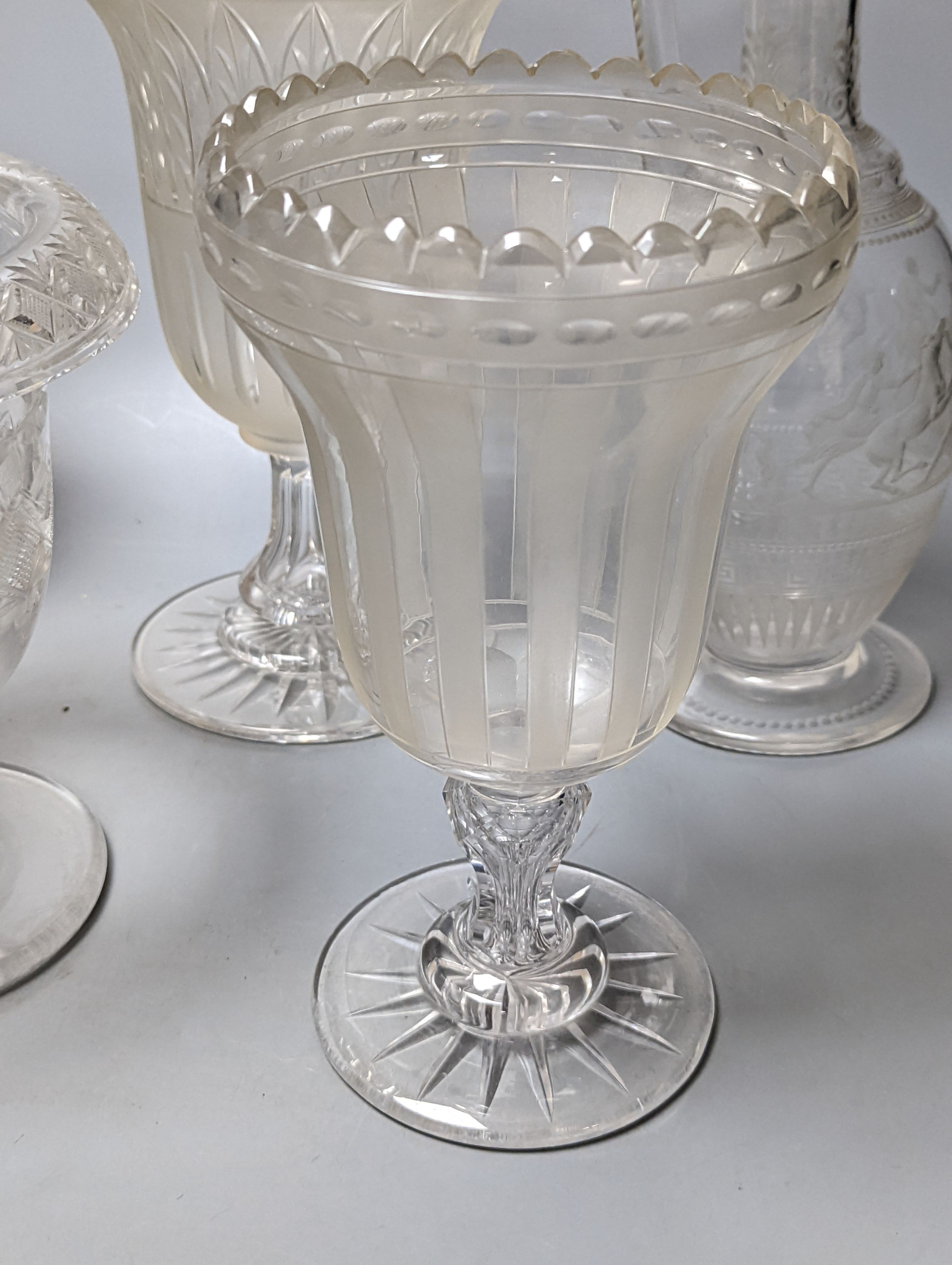 A Victorian wheel engraved ewer,with quinine scenes after the antique, 26 cms high, including 3 celery vases and a decanter.